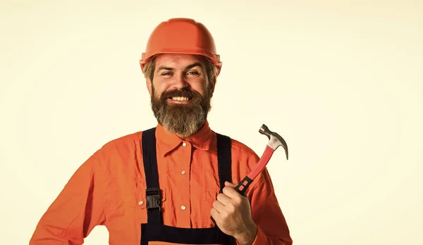 Tekniskt arbete. Nästan alla hushåll har hammare. Beräkna materialkrav för projekt. Professionellt mästerligt reparationstak. Skäggig mogen man i uniform. Killen med hammaren. Bra hammare — Stockfoto