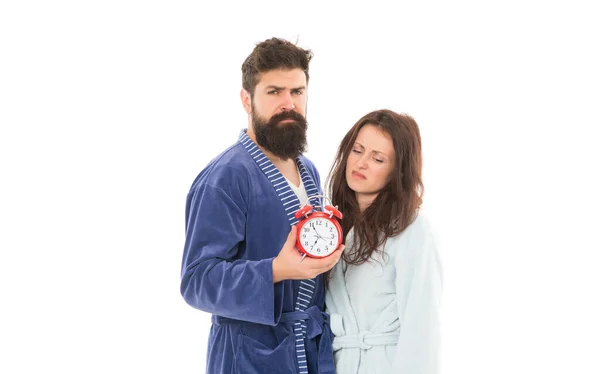 Sleepy couple stressing at early morning. time management. punctuality and discipline. tired family couple. sleepless man and woman in bathrobe. morning wakeup. time to relax. couple hold alarm clock — Stock Photo, Image