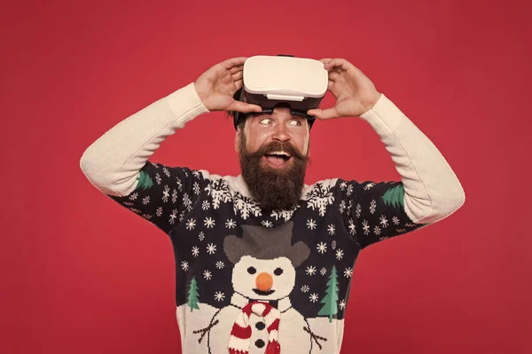 Virtual reality and 3d technology. man wearing virtual reality goggles. imagine best xmas party. happy bearded hipster in vr glasses. man winter sweater play game. indoor vs outdoor activity — Stock Photo, Image