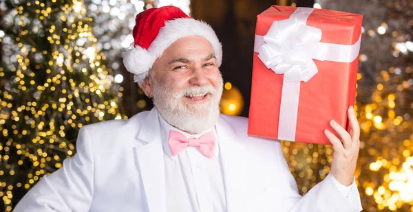 Its for me. merry christmas. happy new year. cheap xmas present and business reward. senior man santa hat hold gift box. bearded businessman get present. holiday decor and illumination