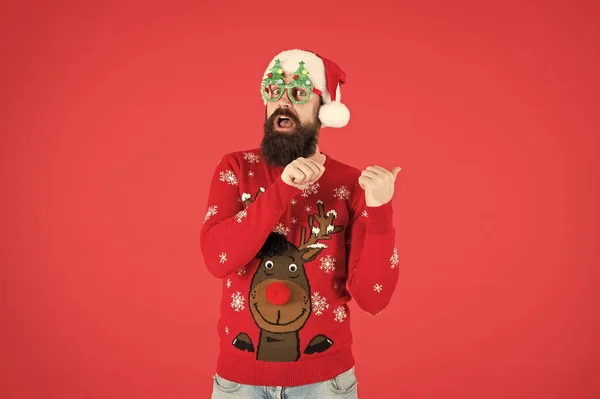 Christmas celebration ideas. Happy new year celebration. Join holiday celebration. Party outfit. Sweater with deer. Winter presentation. Hipster bearded man wear winter clothes red background — 스톡 사진