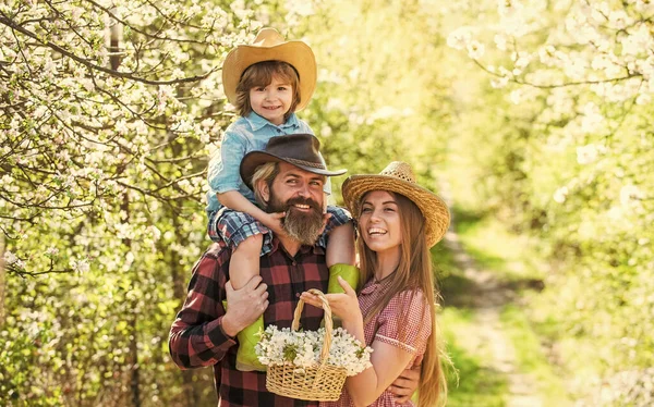 Happy family day. Mother father and cute son. Family farm. Parents growing little baby. Spend time together. Lovely family outdoors nature background. Farmers in blooming garden. Ranch concept — Stock Photo, Image