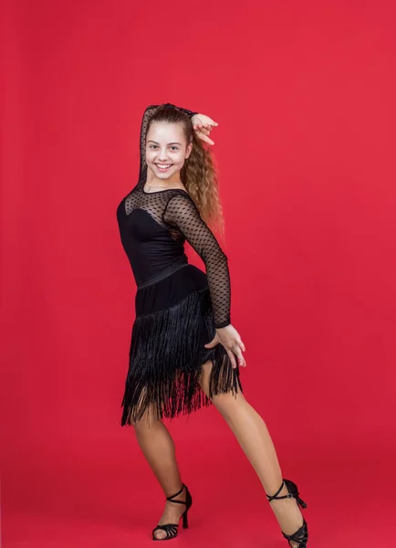 kid girl pretty ballroom dancer wear black dress in dance pose, dancing school