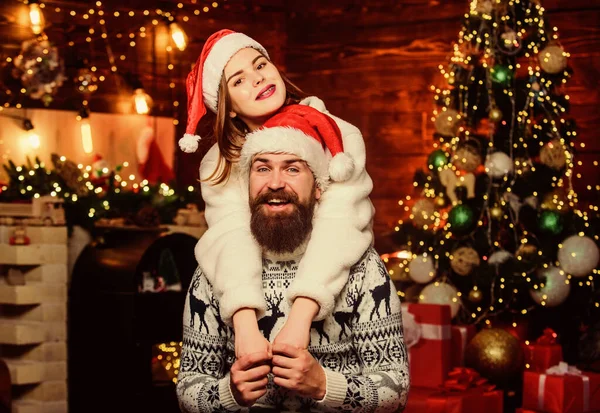 Festive spirit. Lovely married couple cuddle christmas tree background. Christmas is time for giving. Couple in love enjoy christmas holiday celebration. Good vibes. Family tradition. Cheerful mood