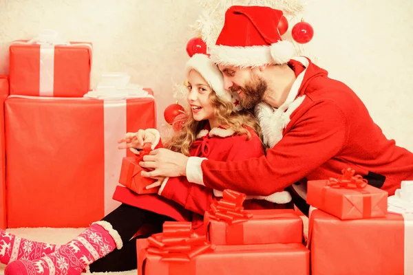 Make your childs holiday extra special this year. Father christmas concept. Christmas gift for child. Dad in santa costume give gift to daughter cute kid. Happy childhood. Christmas family holiday