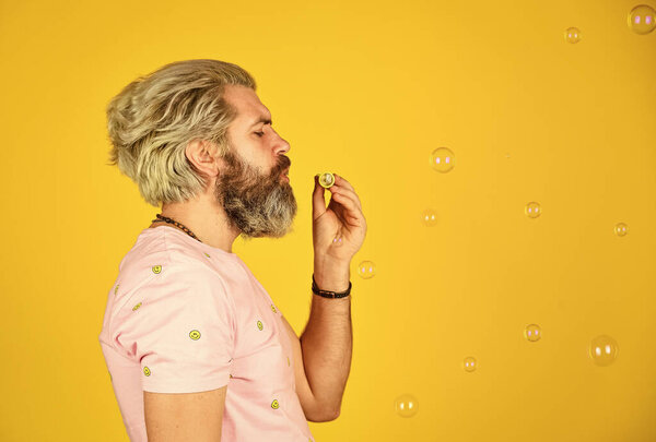 Blow inflate bubbles. Forever young guy. Positive. Infantility concept. Carefree man soap bubbles. Summer vacation. Happy playful bearded hipster and soap bubbles. Happiness and joy. Good vibes