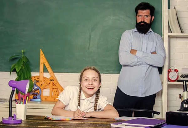 Talented pedagogue. Work together to accomplish more. Man bearded pedagogue. Homeschooling with father. Find buddy to help you study. Private lesson. Pedagogue skills. School teacher and schoolgirl