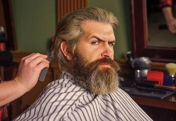 Facial care. hipster with dyed beard and moustache. man want new hairstyle. male beauty and fashion. mature man at barbershop. brutal bearded man at hairdresser. professional barber with male client