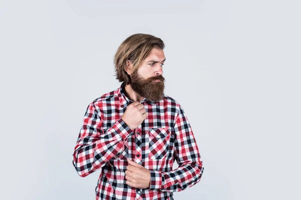 Handsome confident man has perfect hairstyle. bearded man in checkered shirt. male beauty concept. Portrait of bearded hipster. guy with long lush beard and mustache on face — Stock Photo, Image