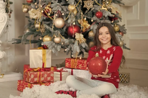 Decorating Christmas tree. Christmas tree ball selective focus. Red ball in hands of happy girl. Christmas ball ornament. Glitter ball decoration. Xmas bulb or bauble. New year — Stock Photo, Image