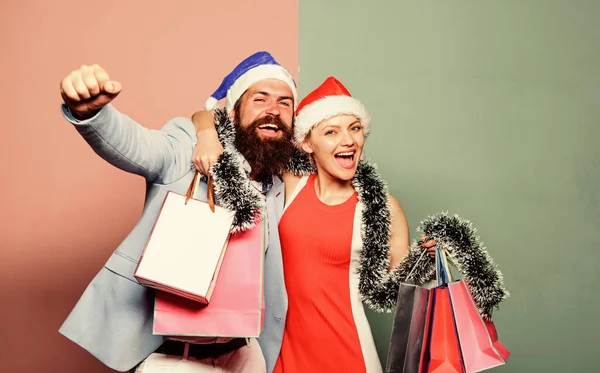 Merry christmas. Cheerful couple Santa hats hold paper bags. Buy gifts. Happy new year. Family shopping. Join celebration. Prepare presents in advance. Man and woman shopping. Christmas shopping — Stock Photo, Image