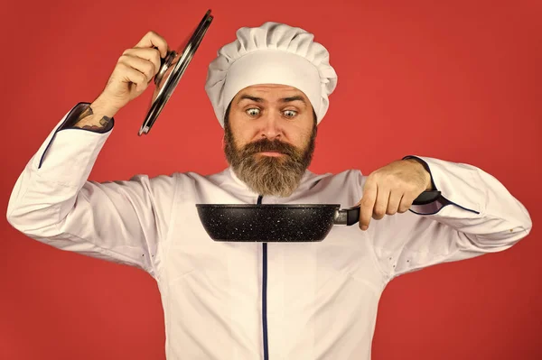 Easy tasty meal prepared at home. Homemade breakfast. Ceramic applied pan. Preparing food in kitchen. Cooking food concept. High quality frying pan. Bearded man cook white uniform. Cooking like pro