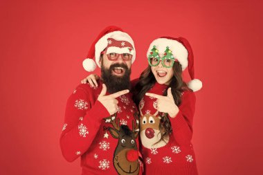 You are next. new year celebration. family together on winter holiday. happy father and daughter love xmas. little girl and dad santa hat. bearded daddy and kid red background. christmas party time