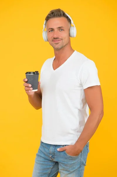 Drinking takeaway coffee is a way of life. Modern man drink coffee listening to music. Takeaway and cafe offering pick-up service. Hot drink. Take-out only — Stock Photo, Image