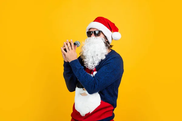 Happy bearded man in santa claus costume singing in microphone celebrate winter holiday of chistmas and feel merry about xmas gifts, christmas karaoke — Stockfoto