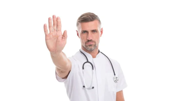Stop coronavirus pandemic gesture of mature man therapist with phonendoscope in uniform isolated on white, covid 19 — Stock Photo, Image