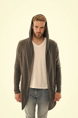 Moda belirleyicisi burada. Beyazda izole edilmiş ciddi bir adam. Sıradan tarzda yakışıklı bir adam. Tıraşsız adam başlık takıyor. Modern bir adamın moda görünüşü. Erkek giyim mağazası. Moda ve tarz