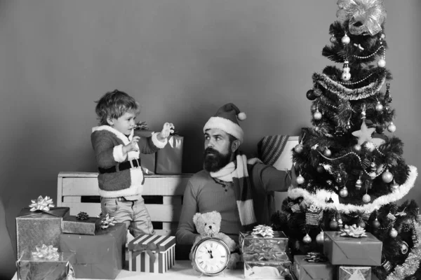 Boy and man with curious faces put ball on tree — Stock Photo, Image