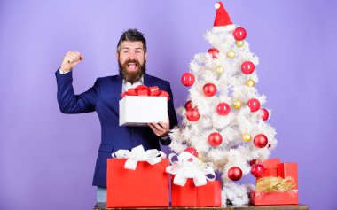 Yeni yıl partisinde başarılı bir iş adamı ödülü. Adam Xmas ağacının yanında iş başarısını kutluyor. İyi tatiller. Kış sezonu satışları. Noel alışverişi. Noel Baba 'dan sakallı adam hediyeleri.