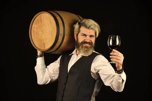I recommend this. Bartender at wine cellar with exquisite drink. experienced sommelier taste wine. barman tasting red wine at degustation. male sommelier appreciating drink. barrel of red wine — Stock Photo, Image