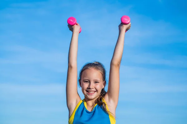 Aim and success. healthy child training with barbells. fitness kid hold dumbbell. weight lifting. teenage girl do exercise. happy childhood. future of sport. warm up for workout in morning — Stock Photo, Image