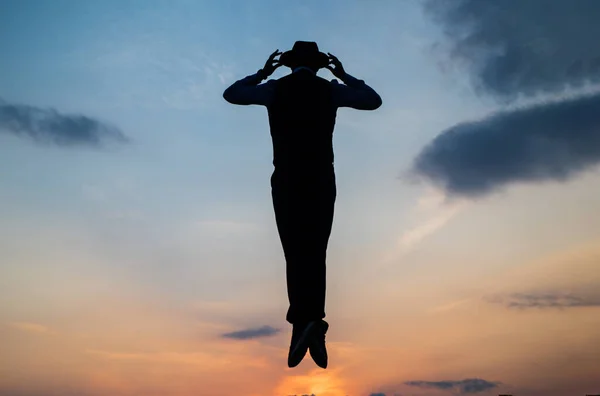 Break the rules. need the inspiration. man feel motivation. fly in sky. jumping man silhouette on sky background. confidence and success. concept of successful future. agile business. loneliness