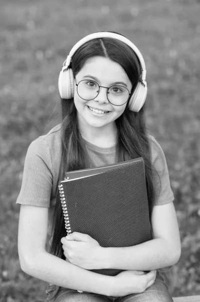 Audio listening and study. Happy child enjoy listening to music. Small girl practise listening skills. Listening course. Distance learning. School and education. Modern life. Feel language of music