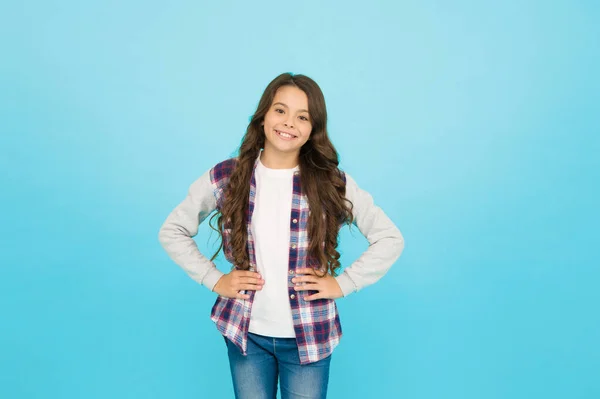 Living happy life. Good mood concept. Positive vibes. Sincere emotions. Cute girl with long hair. Little girl turquoise background. Small girl checkered shirt. Happy international childrens day — Stock Photo, Image