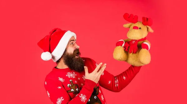Symbol of Christmas. Christmas eve. Gifts for kids. Dear Santa. Bearded man reindeer toy. Hipster man hold Christmas gift. Happy man playful mood. Plush deer. Happy new year. Helping Santa Claus — Stock Photo, Image
