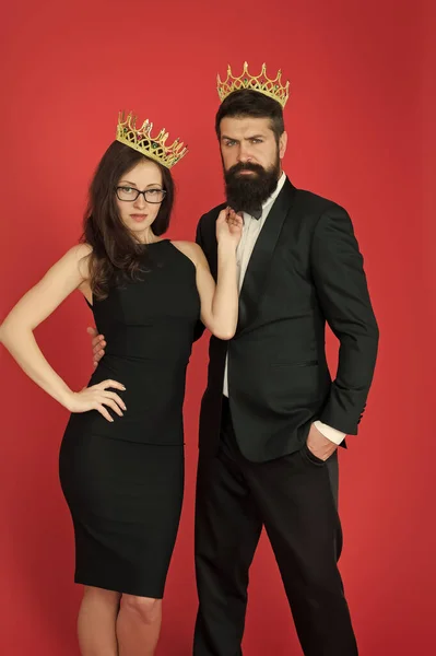 Perfect match. Elite society. Being recognised and proud. Proud couple. Woman and bearded man wear crowns. Selfish egoist. Superiority complex. Fame and popularity. Famous couple. Proud of their love