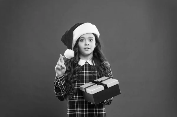 Want my wish. time for christmas holiday presents. small girl in santa hat. cheerful child red background. christmas kid shopping. best gift for xmas. little girl open gift box. happy new year gift — Stock Photo, Image