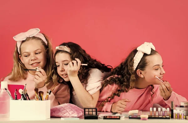 In own style. family bonding time. childhood happiness. retro kids put on makeup. skin care cosmetics for children. beauty and fashion. three happy girls at hairdresser. friendship and sisterhood