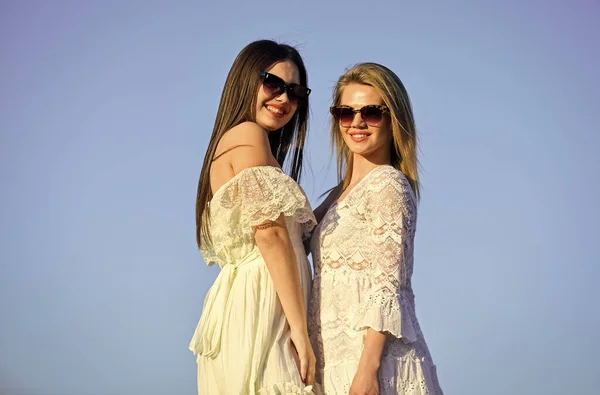 Sisterhood and female community. Female friendship. Female power. Summer fashion. Find woman inner strength. Harmony and balance. Femininity concept. Beautiful women on sunny day blue sky background