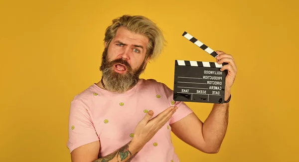 Actor casting. Shooting scene. Favorite series. Action. Cinema production. Creative producer. Bearded man hold movie clapper. Film making concept. Clapperboard copy space. Watch movie. Film director