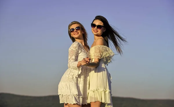 Harmony and balance. Psychology concept. Beautiful women on sunny day blue sky background. Sisterhood and female community. Female friendship. Female power. Summer fashion. Find woman inner strength