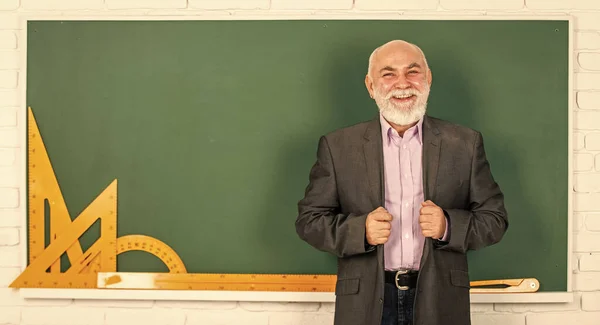 Professor sénior usa ferramentas matemáticas. O professor barbudo explica a geometria no quadro negro. de volta à escola. Ferramentas gráficas matemáticas. aula de trigonometria em sala de aula. obter conhecimento aqui — Fotografia de Stock