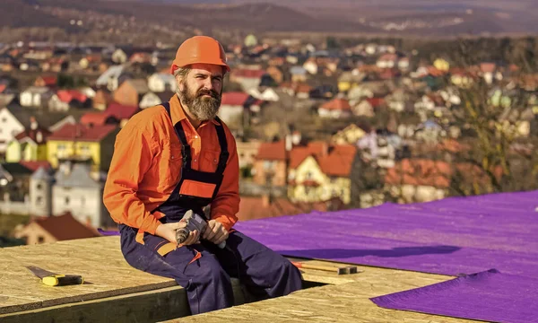 建筑工地房顶结构施工的房顶工。屋顶穿着安全制服检查。Roofer的工作。屋顶的工作工具。建筑业和防水。安全专家 — 图库照片