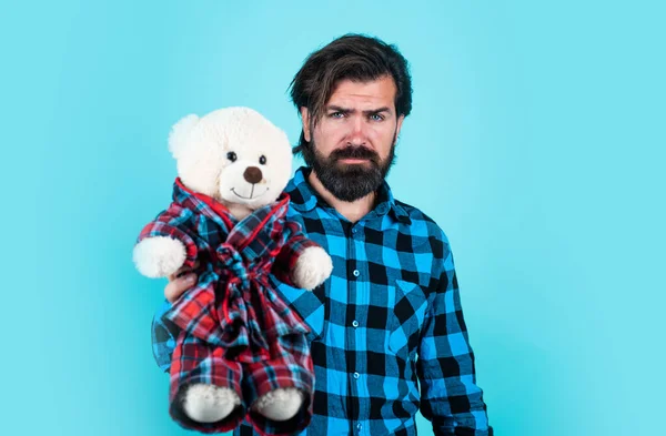 Brutal man in checkered shirt has long beard hold teddy bear toy, toy shop — Stock Photo, Image