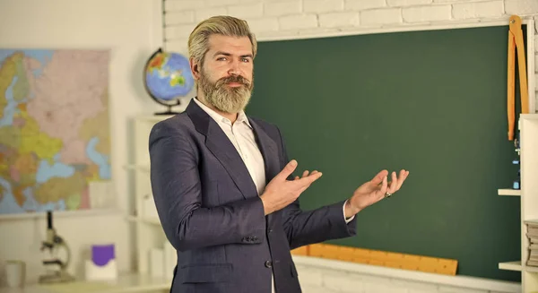 Modern school. Knowledge day. Back to school. Teachers day. Bearded man in classroom chalkboard copy space. Graduation and final examination. School. Teacher school lesson. Study and education