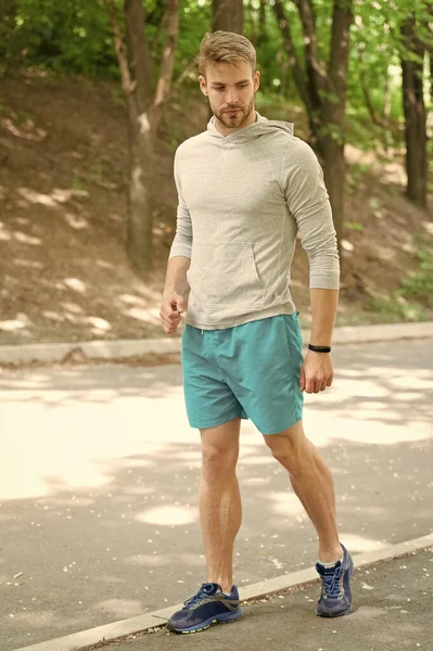 Fastest way to get in shape. Sportsman walk on sidewalk. Strong sportsman wear fitness uniform. Sportsman training outdoors. Sportsman or athlete. Healthy lifestyle. Sport and fitness. Daily workout — Stock Photo, Image