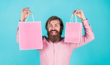 Tişörtünde alışveriş çantası olan olgun, vahşi bir hippi.