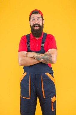 Mekanik servis üniformalı vahşi sakallı adam yetenekli tesisatçı ve atölyede çalışıyor.