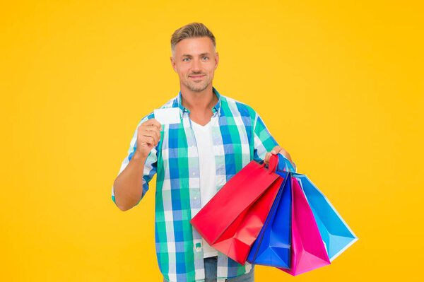 shopaholic. christmas sales and discounts. birthday present packs. guy with credit card. happy man carry shopping bags. black friday. shopper with packages. prepare for holidays. Choosing the best