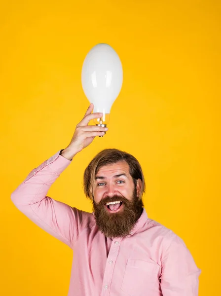 Brain idea. save the energy. innovation. happy bearded man holding lamp bulb. creative idea. inspired with new idea. mature brutal hipster brainstorming. energy saving lamp. electricity and lighting — Stock Photo, Image