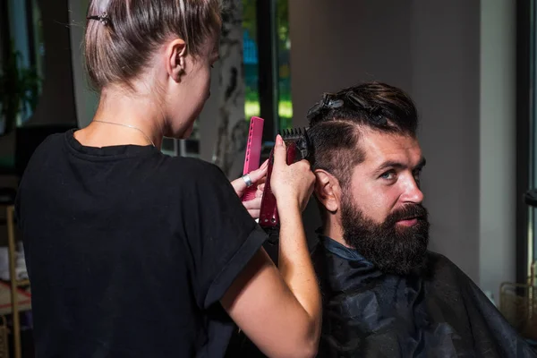 barber master cut hair. mature hipster with beard at hairdresser. brutal hipster making new hairstyle. barbershop. male trendy hairdo. perfect haircut with blade razor. Confident in his perfect style