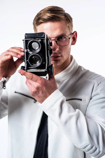 Young photographer take photograph looking in eye of retro camera isolated on white, session — Stock Photo, Image