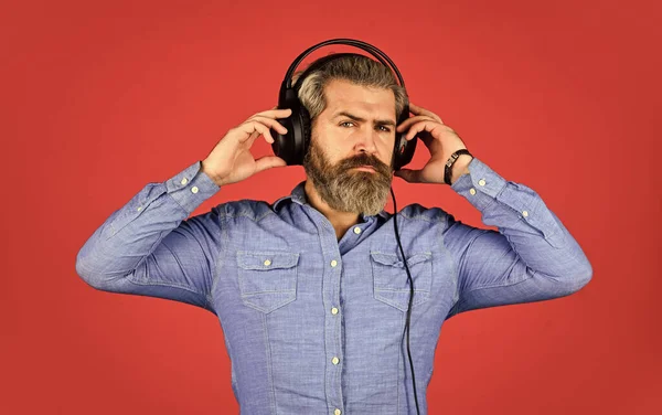 Um homem a ouvir música com os auscultadores. Homem barbudo hipster nos auscultadores. A ouvir música. Está na hora de relaxar. Um hipster brutal usa auscultadores. cantando e dançando. Desfrutando de sua música favorita — Fotografia de Stock