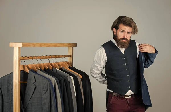 Perfect design. Man in boutique. Man with suit. tailor in his workshop. Handsome bearded fashion man in classical costume suit. Man in custom tailored suit presenting expensive tailored tuxedo — Stock Photo, Image
