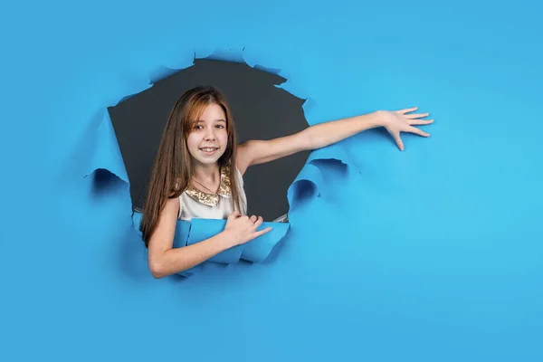 cheerful child has long hair. happy kid feeling joy and happiness. lets have fun. hairdresser concept. healthy and strong hair. transitional age. presenting product. teen girl on blue background