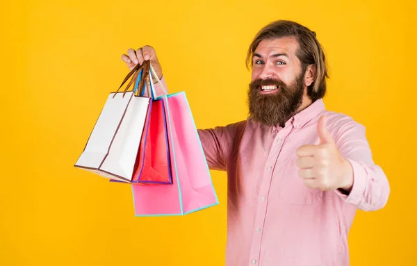 Brutal bearded male man hold present or gift package, black friday — Stock Photo, Image